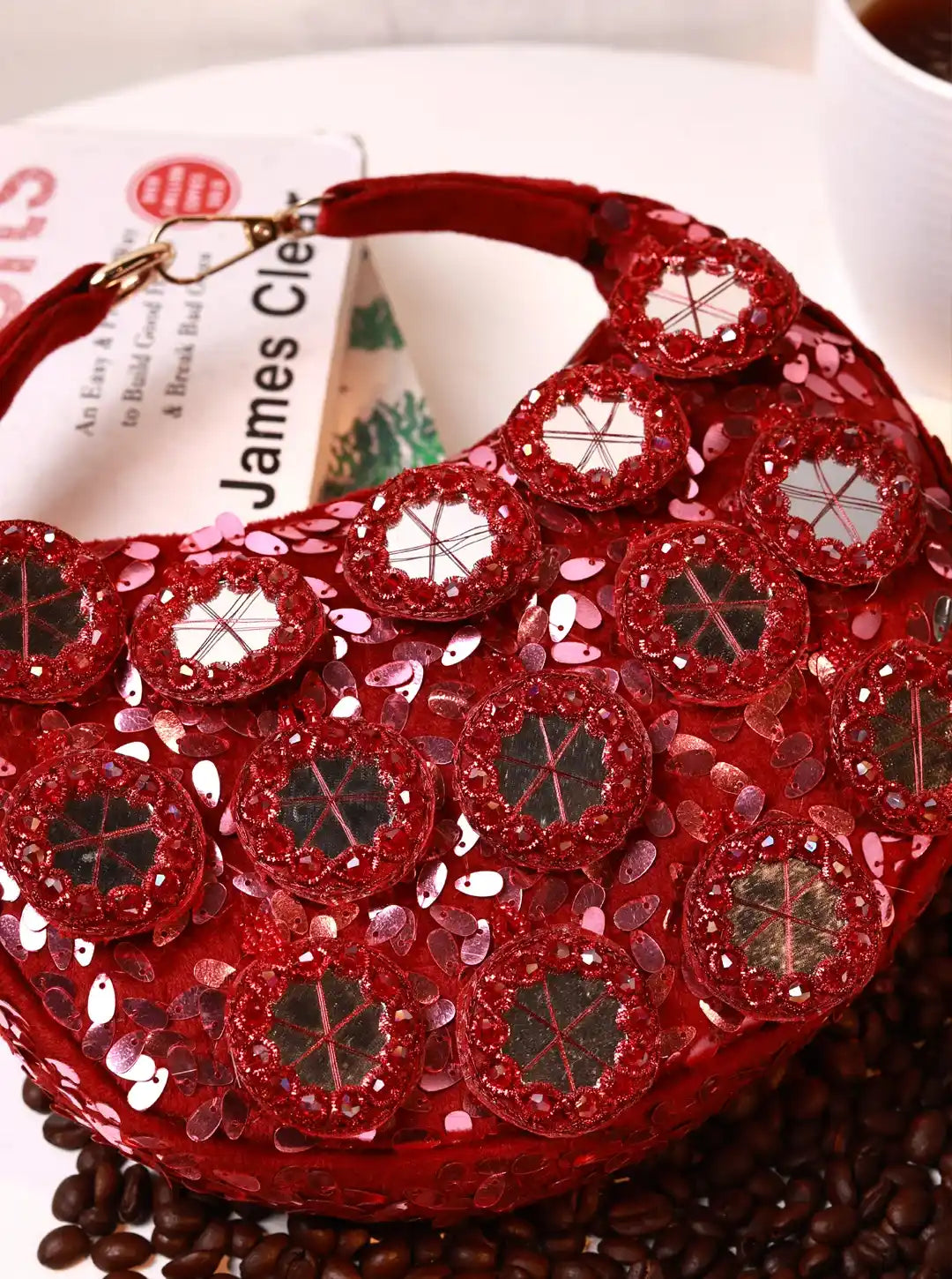 Red sequin handbag on a surface with a blurred background