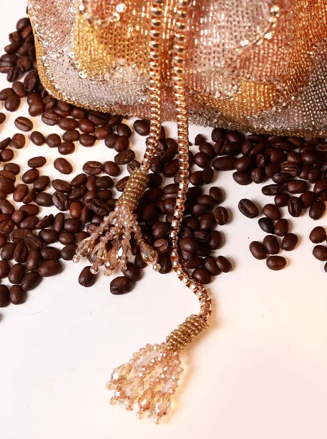 Decorative bag with tassel on a background of coffee beans