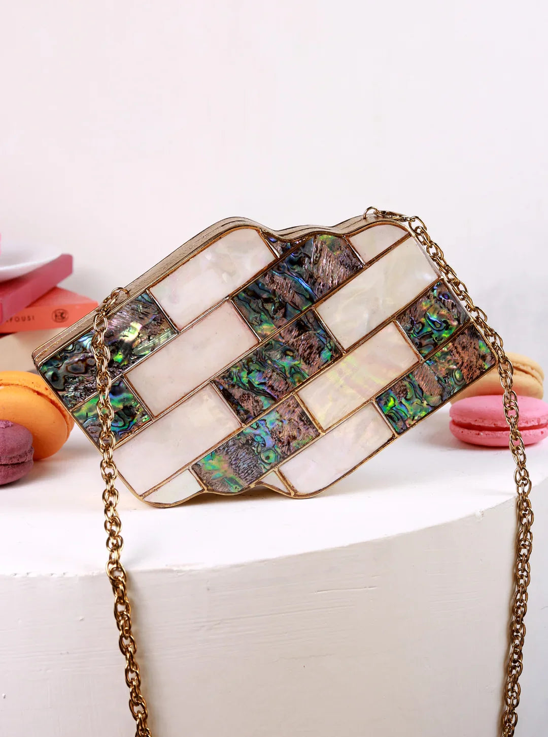 Decorative clutch bag with mosaic design on a white surface