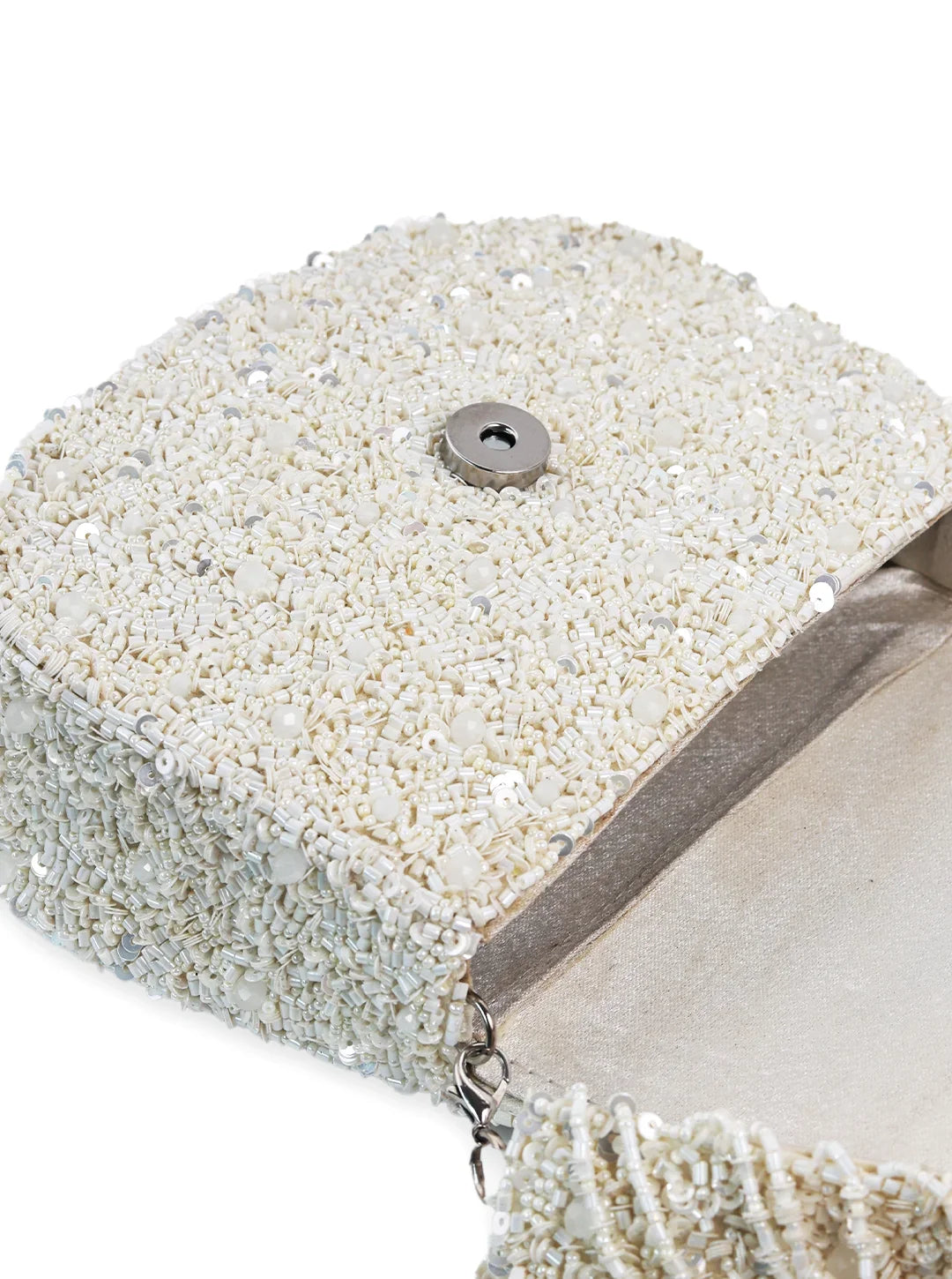 Close-up of a beaded clutch bag with a button detail on a white background