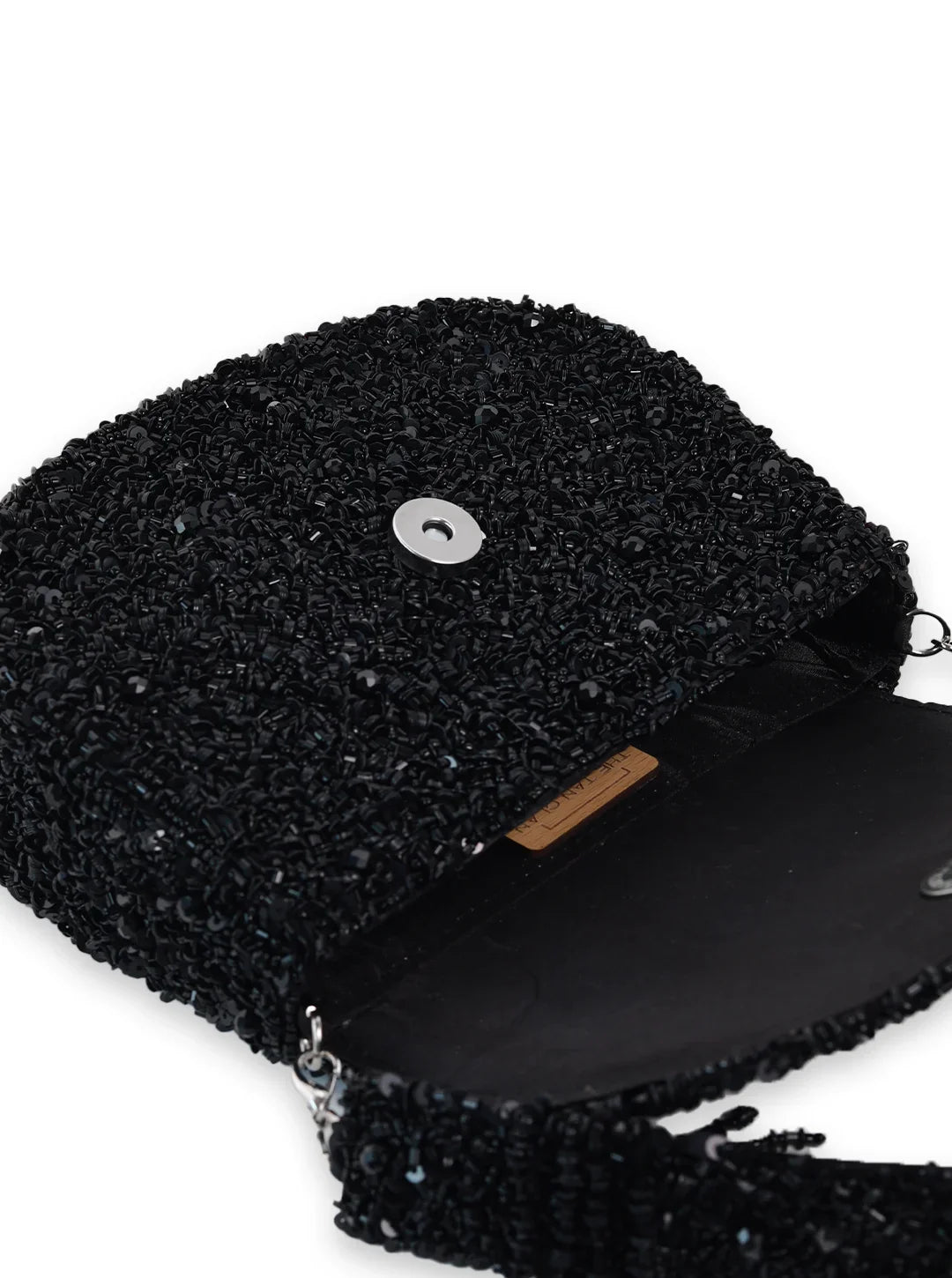 Black textured clutch bag with a wooden interior on a white background