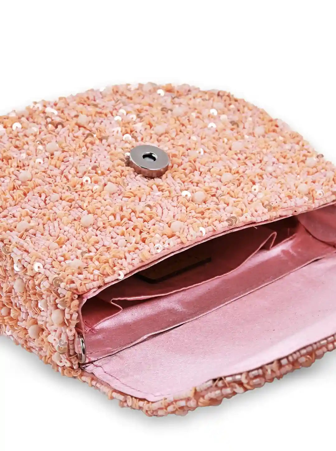 Pink glittery clutch bag with a button on a white background