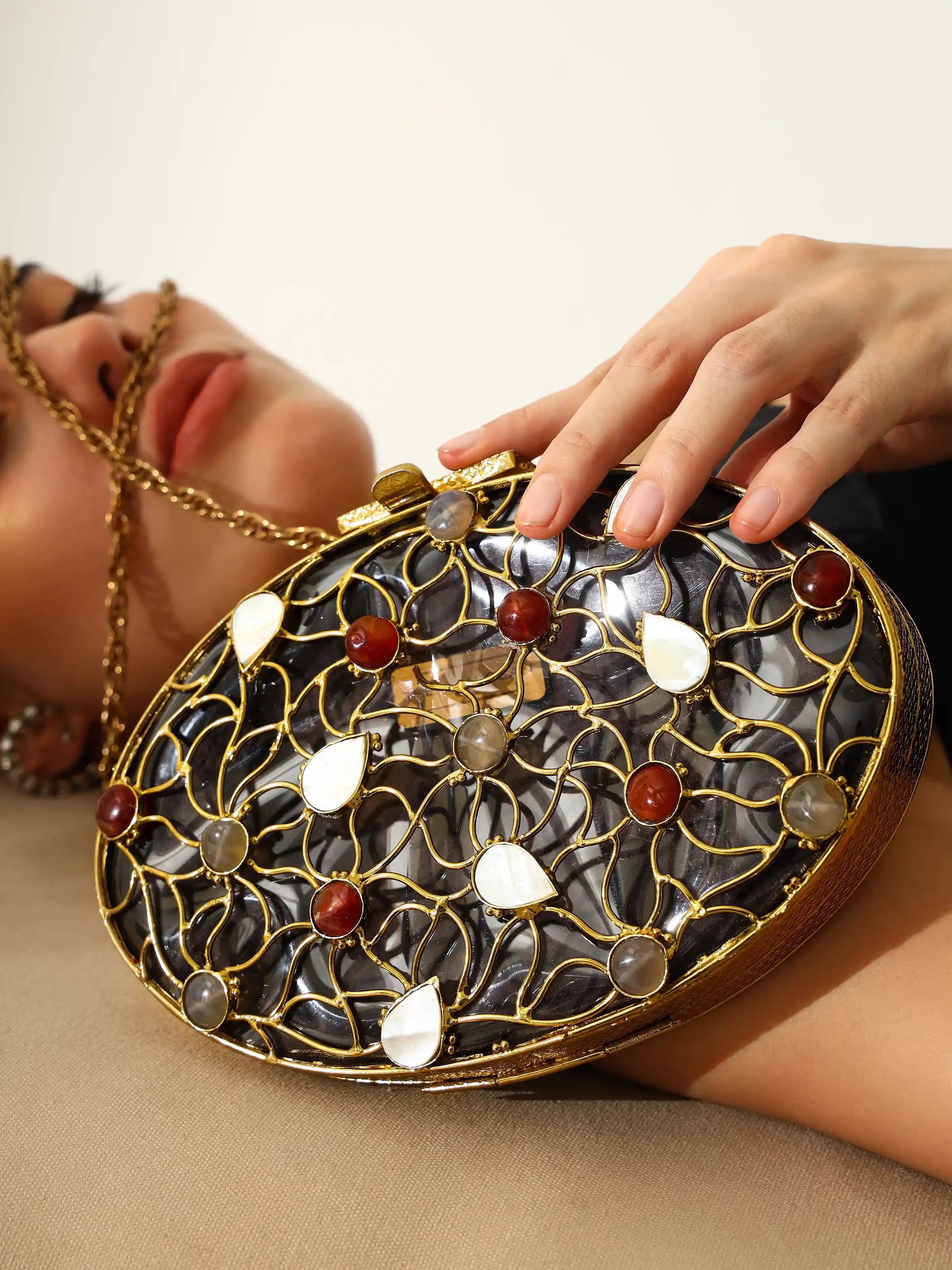 Close-up of a decorative clutch bag with intricate design and gemstones.