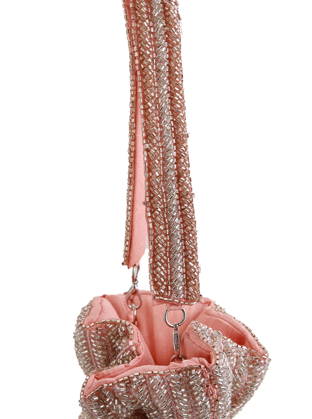 Pink handbag with sparkling chain strap on a white background
