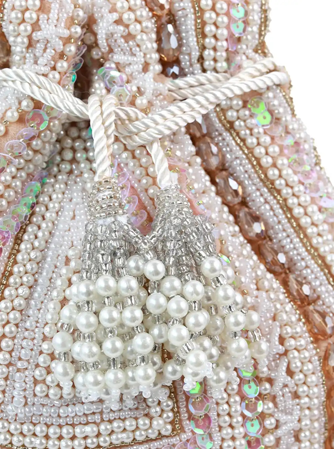 Close-up of a beaded handbag with pearls and sequins on a white background