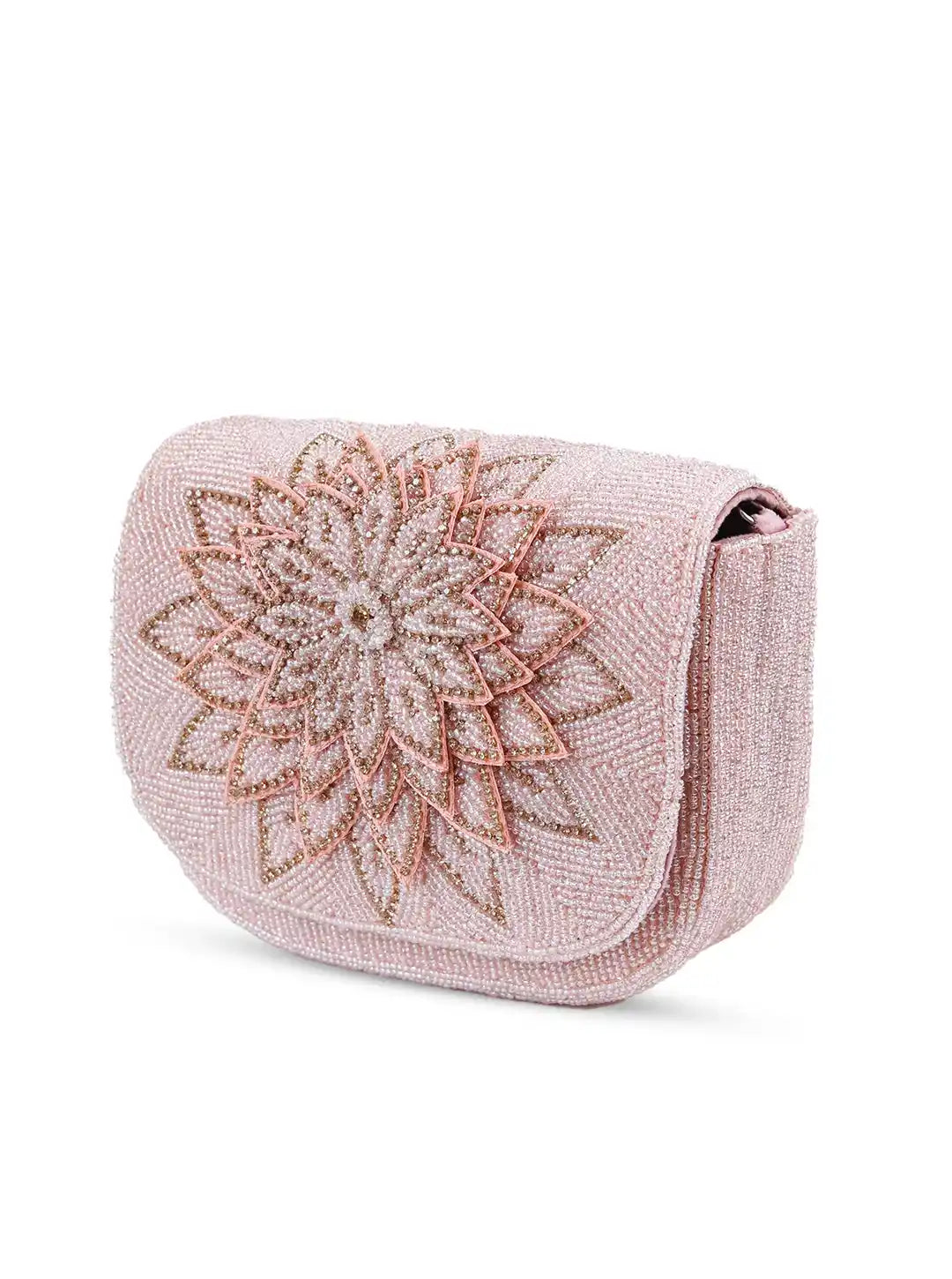 Pink handbag with floral beaded design on a white background