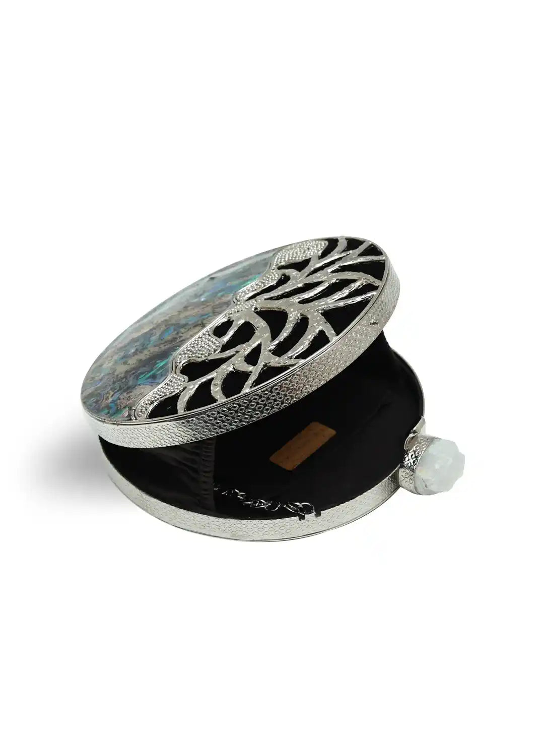 Decorative compact mirror with intricate design on a white background