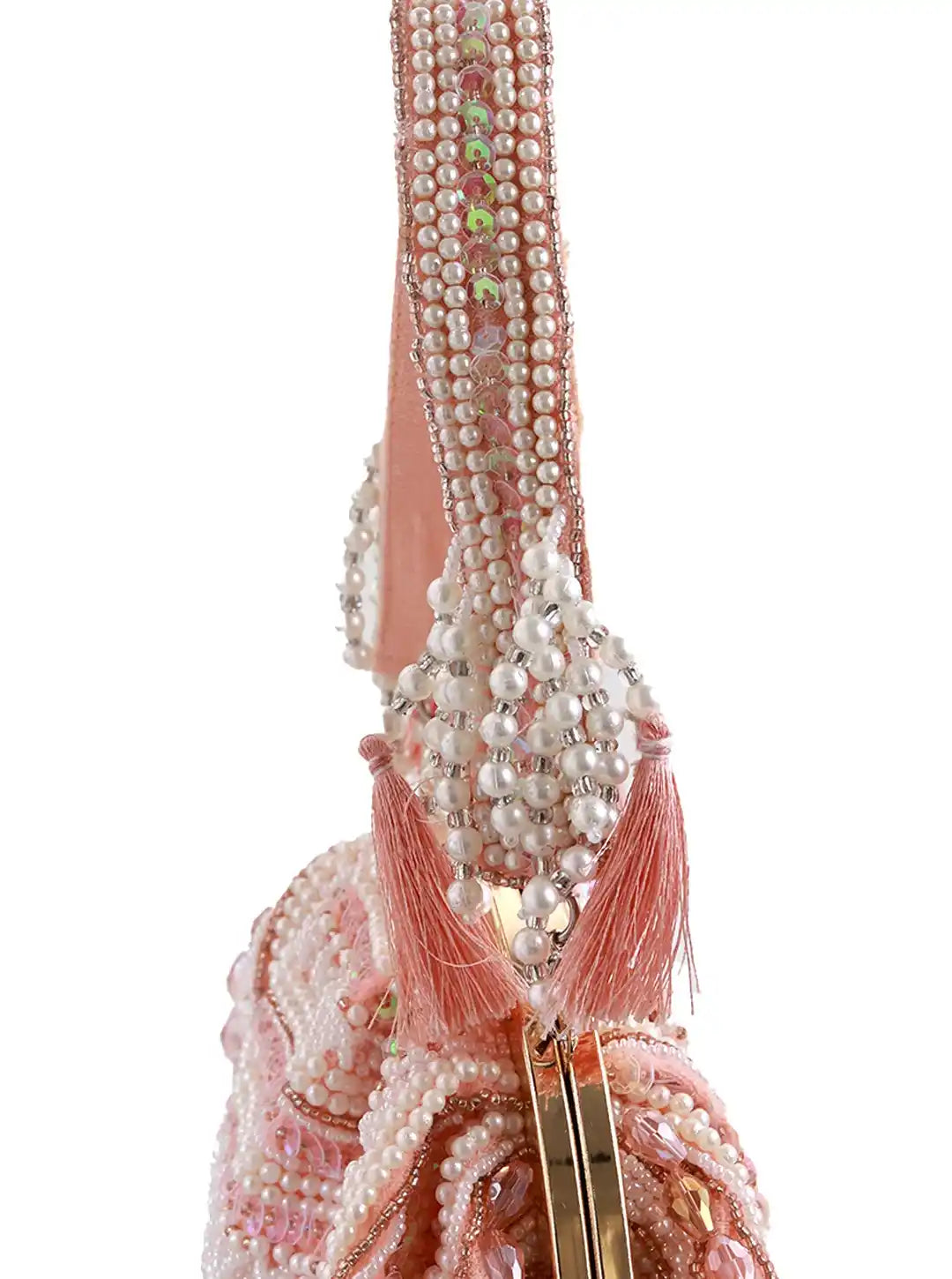 Pink handbag with pearl detailing on a white background