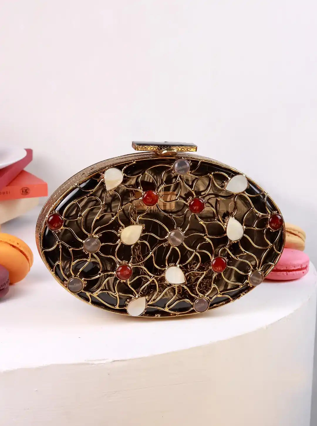 Decorative clutch bag with intricate design on a white background