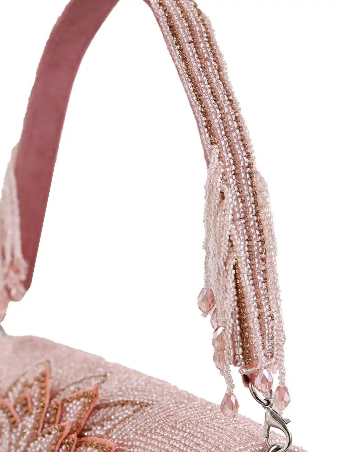 Close-up of a beaded handbag strap with intricate detailing on a white background