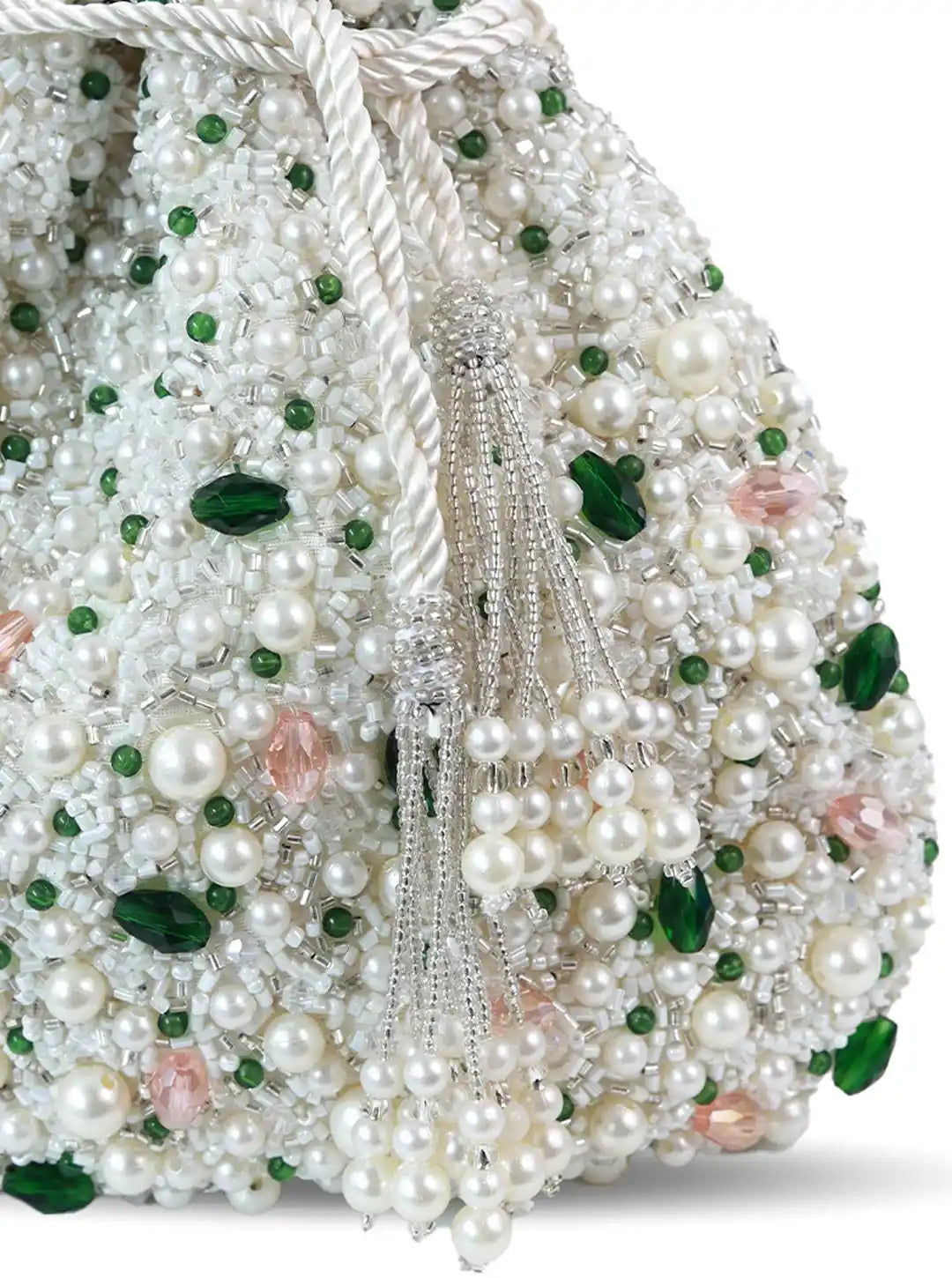 Decorative item with pearls and green leaves on a white background