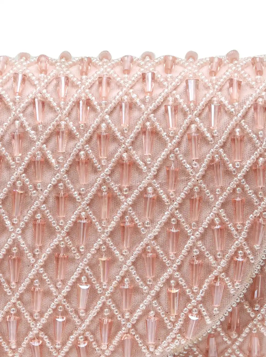Close-up of a pink beaded fabric with a diamond pattern