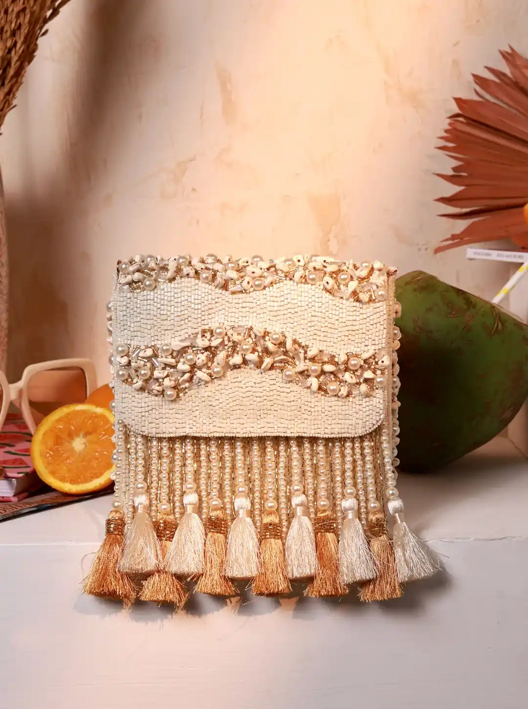 Decorative wall hanging with tassels and beads on a neutral background