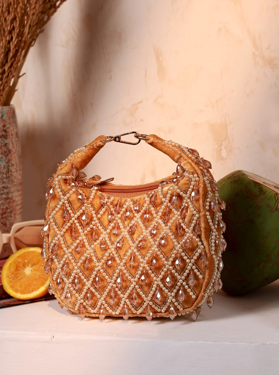 Decorative handbag with beaded design on a neutral background