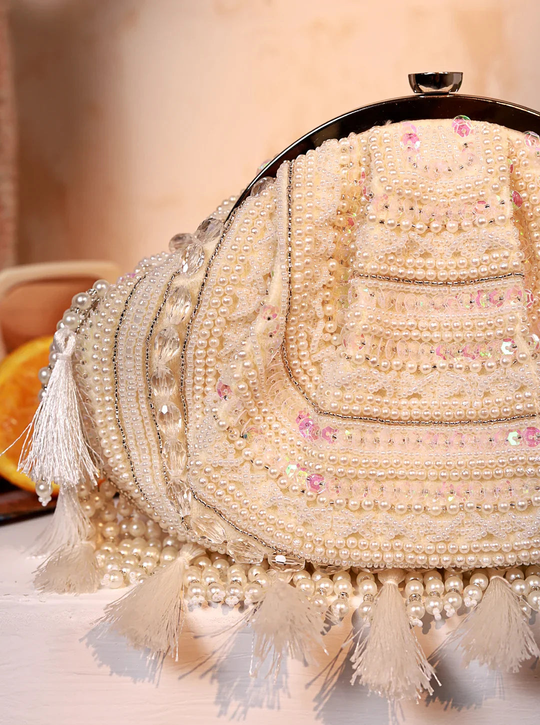 Decorative handbag with pearls and tassels on a soft background
