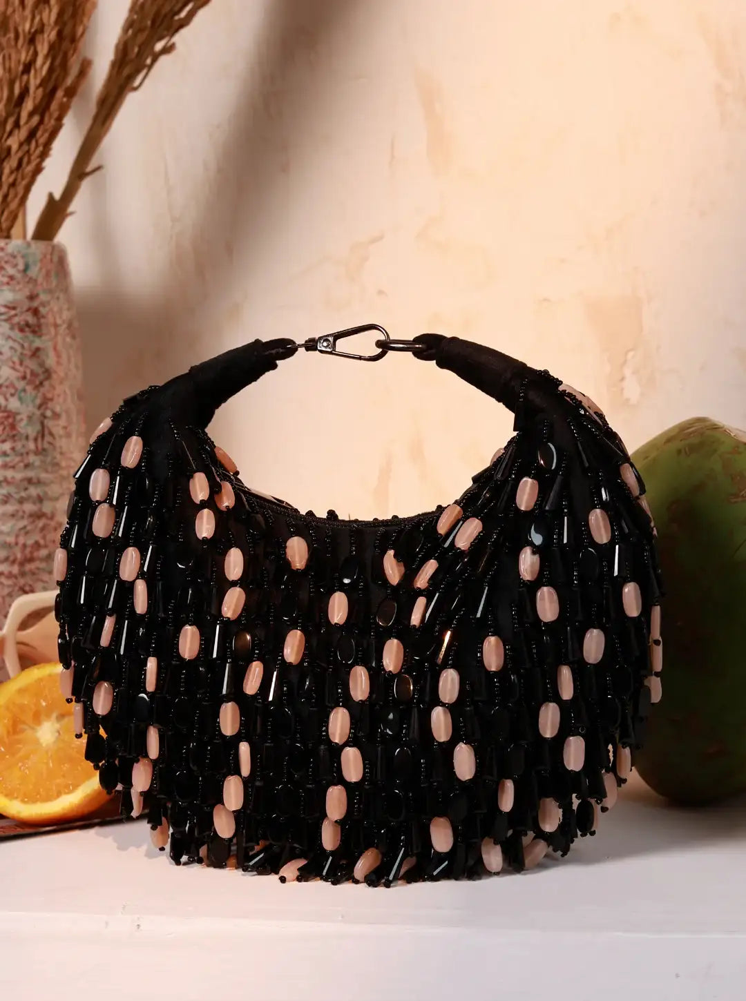 Black beaded handbag on a light background