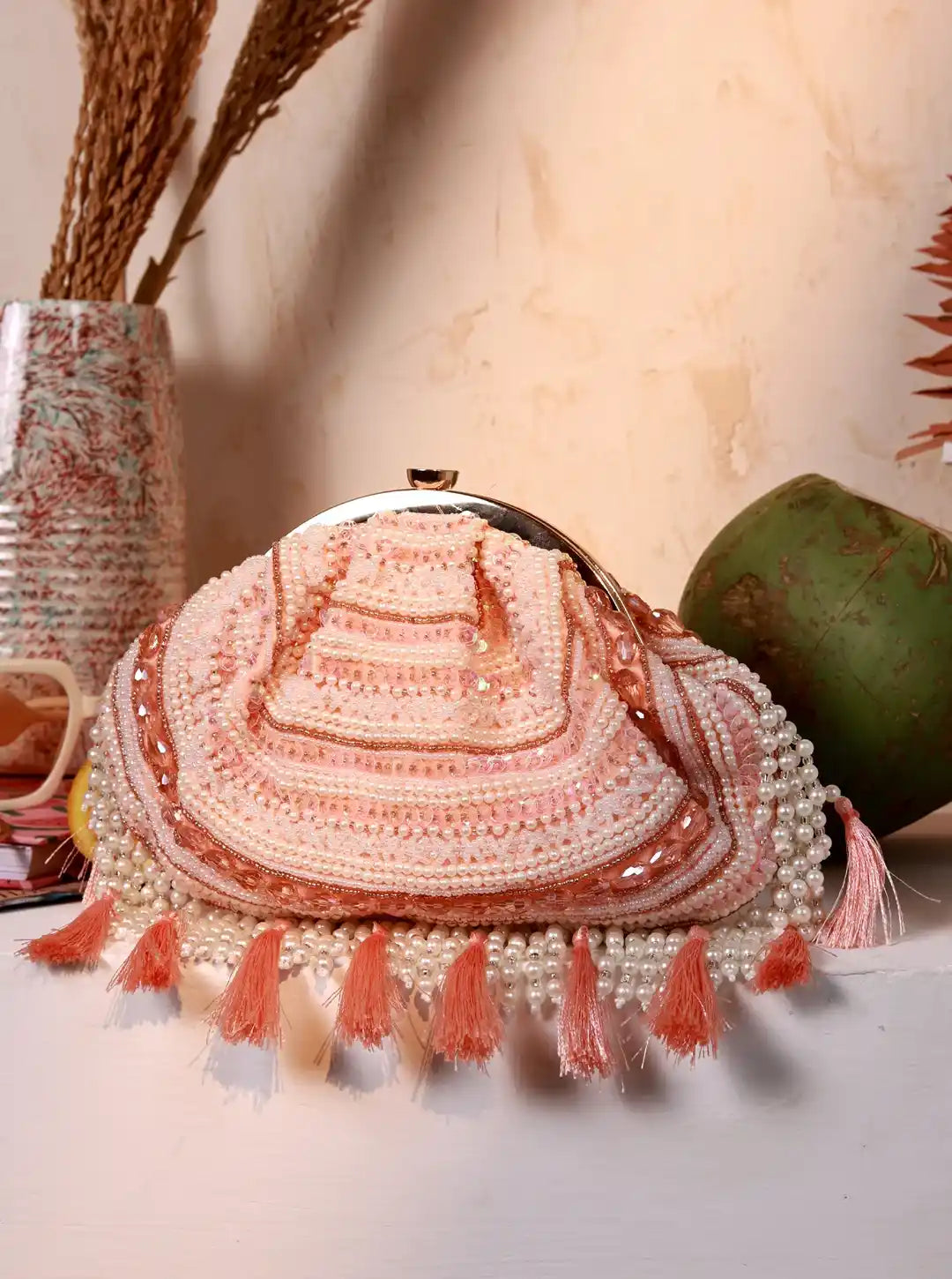 Handmade beaded bag with tassels on a neutral background