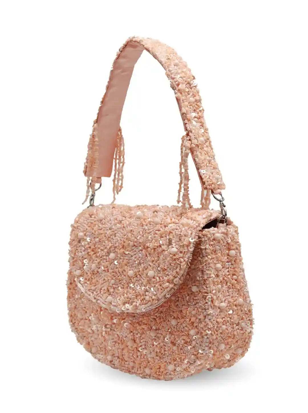 Pink glittery handbag with a strap on a white background