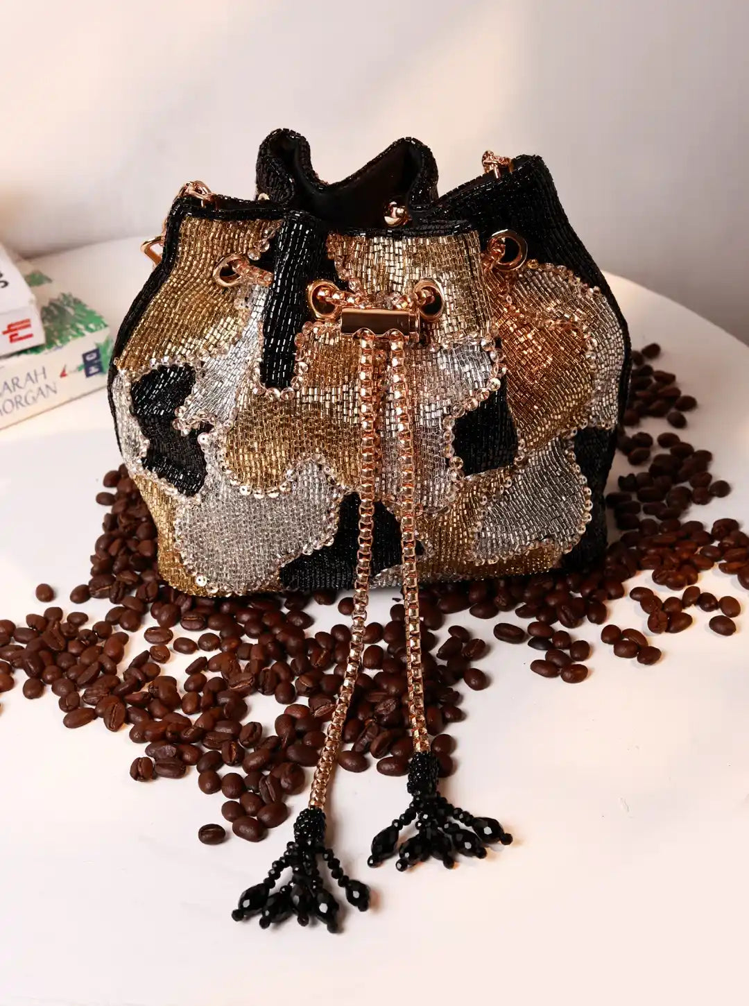 Beaded handbag with cow pattern on a surface with coffee beans