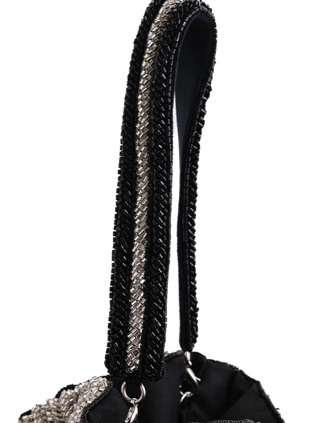 Close-up of a black handbag handle with decorative elements on a white background