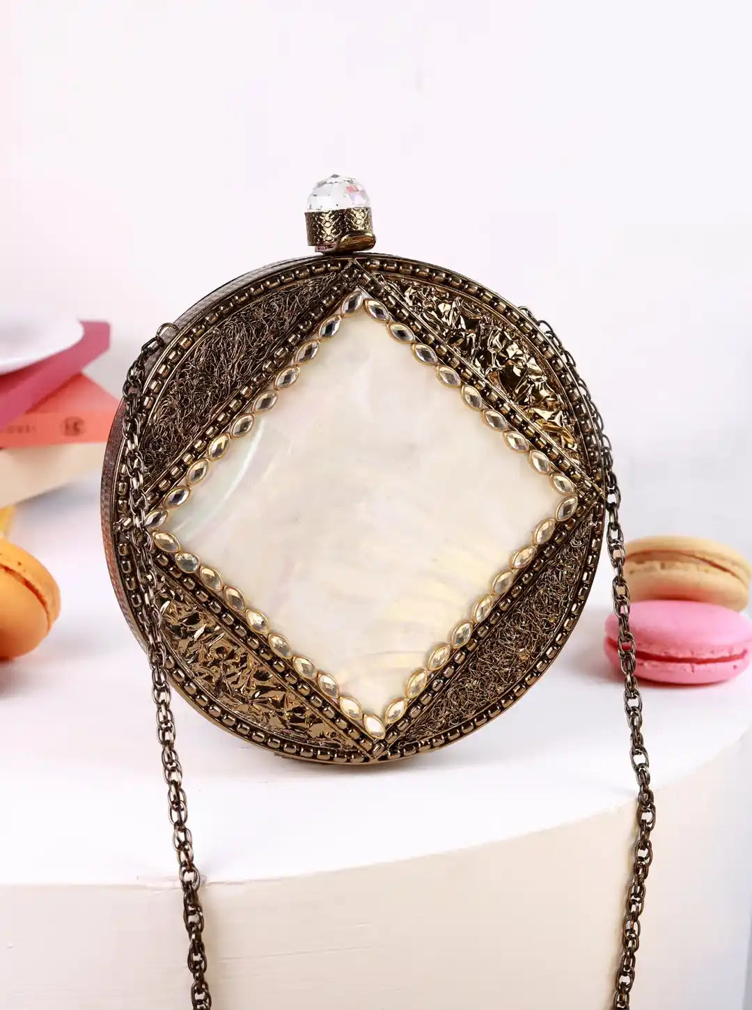 Decorative clutch bag with chain strap on a white background