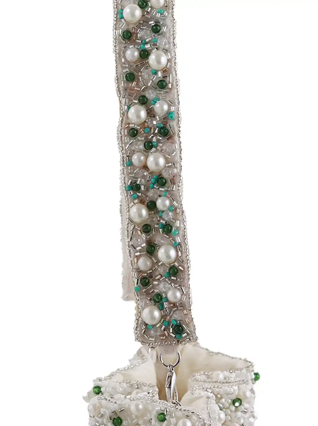 Decorative item with pearls and green beads on a white background