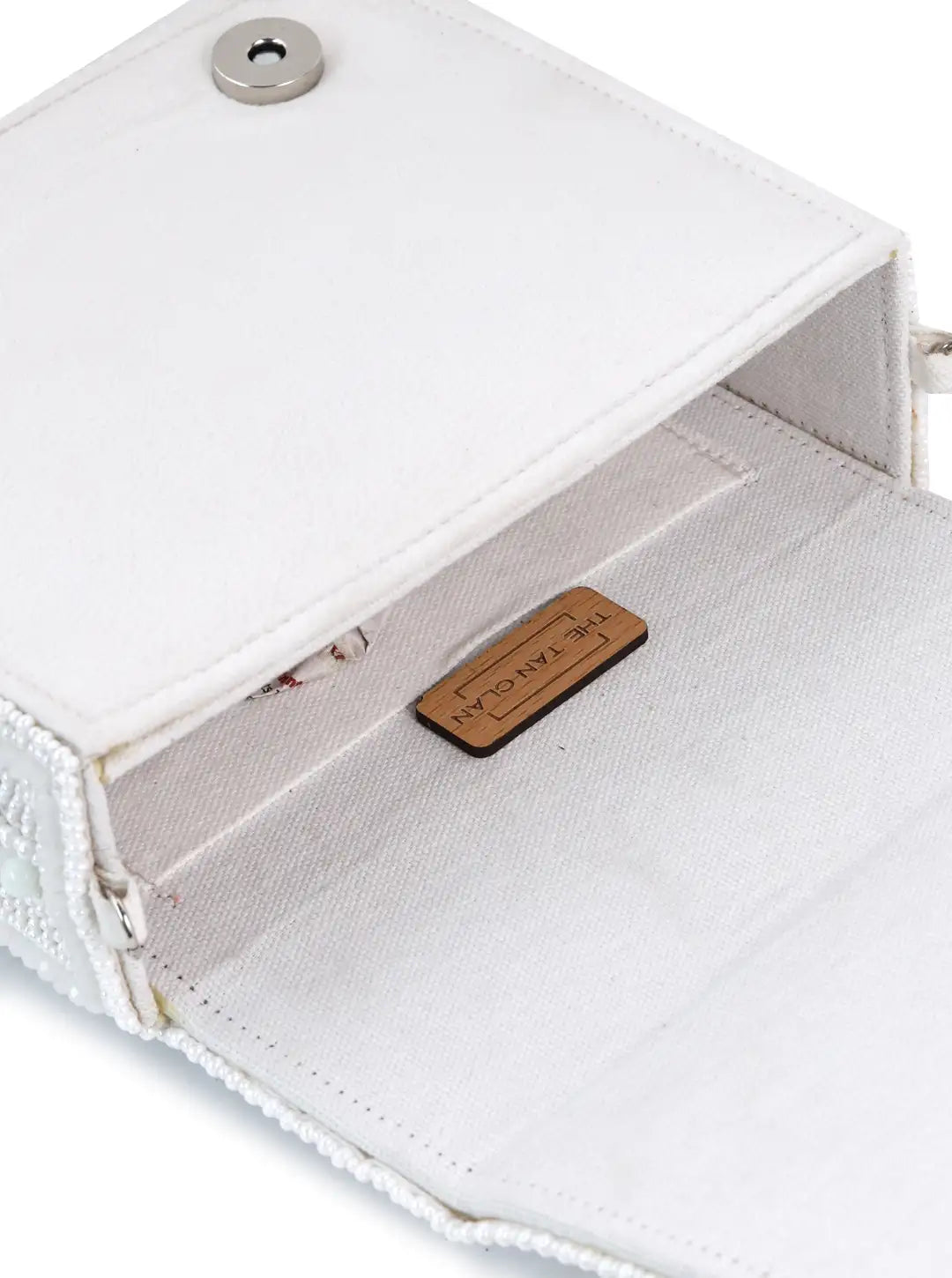 Close-up of a white fabric product with a wooden label inside