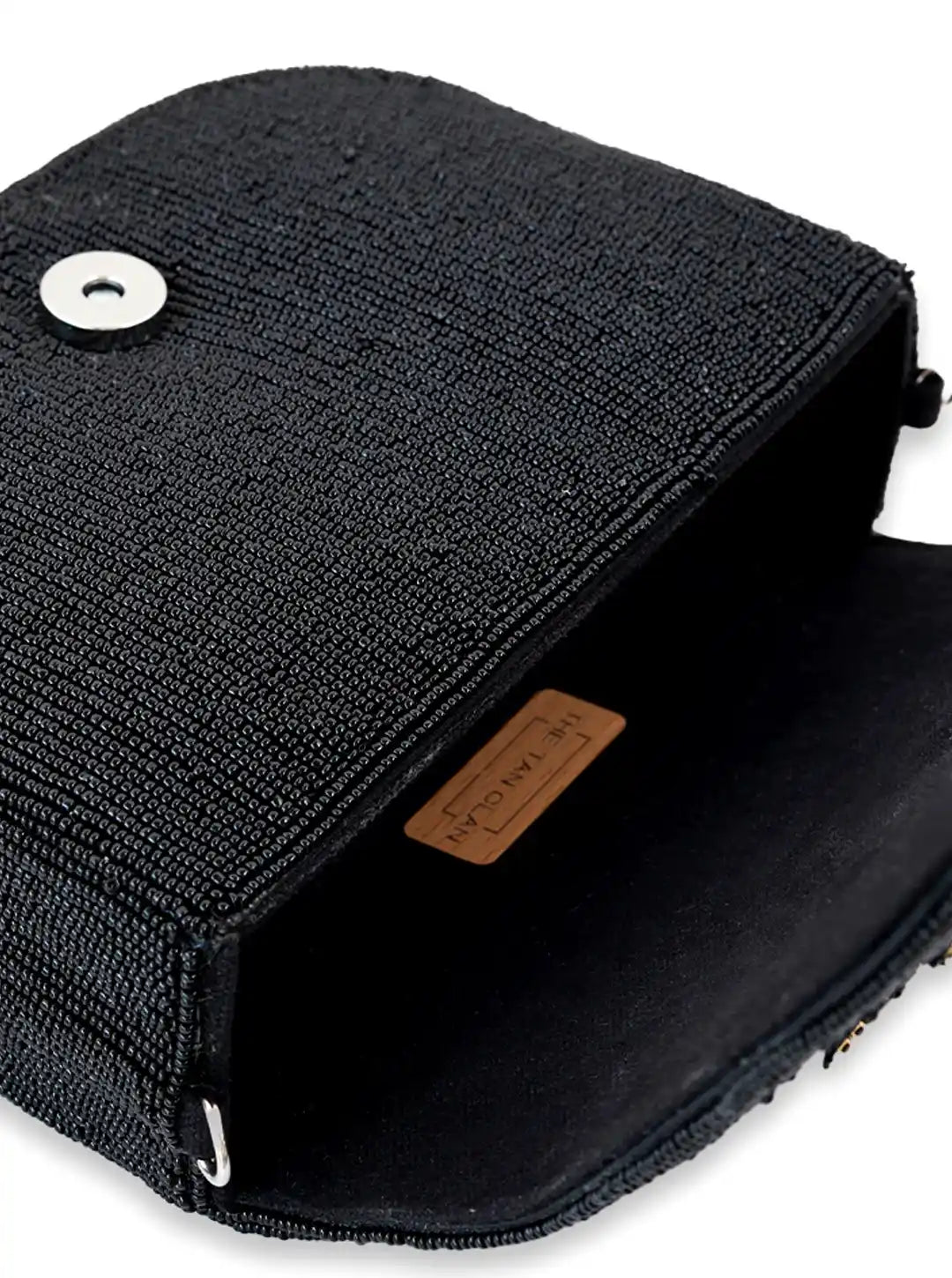Black textured bag with a brand label on a white background