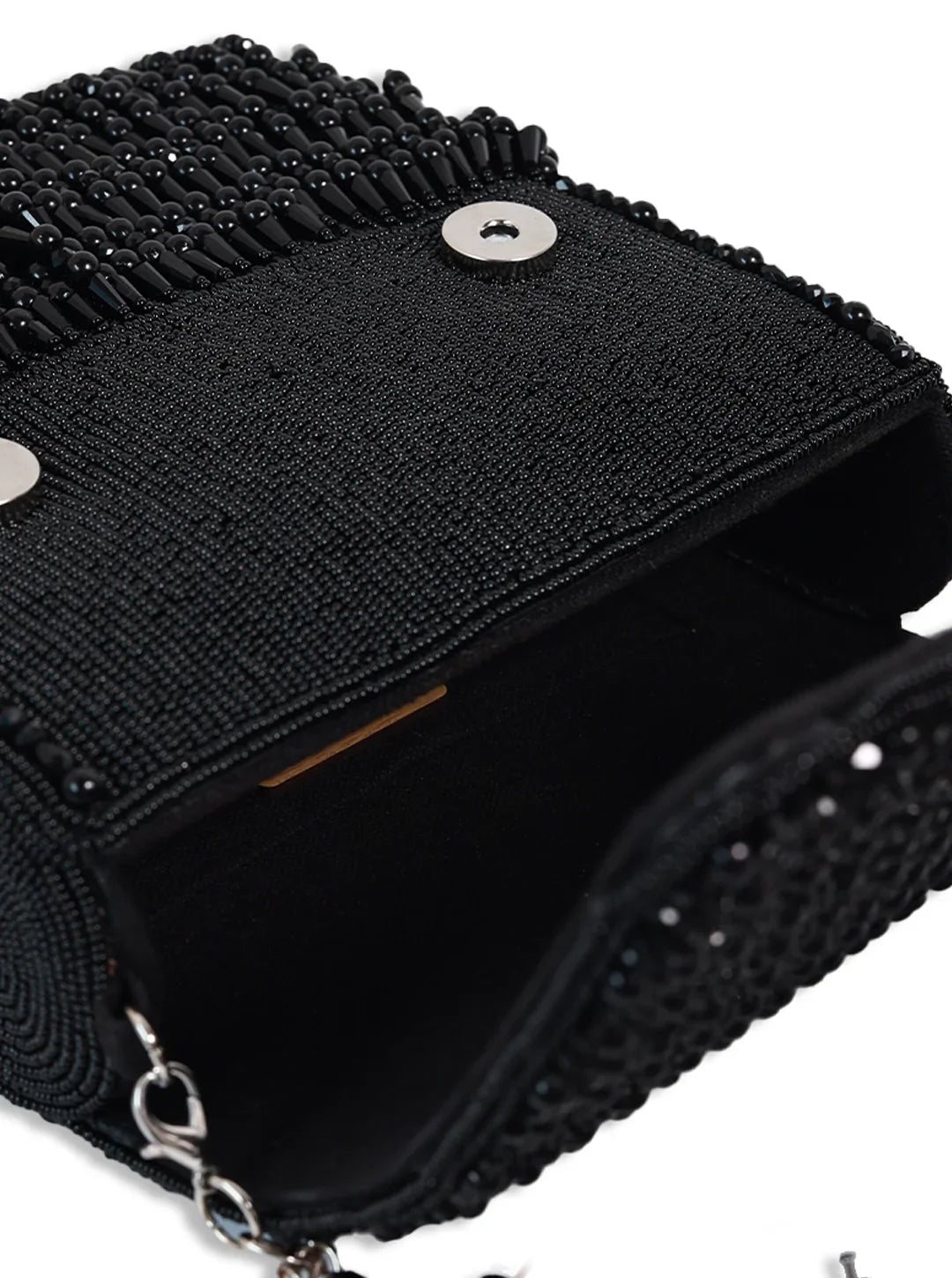 Black textured handbag with chain detail on a white background