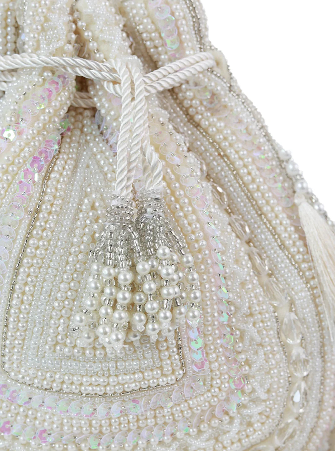 Close-up of a beaded handbag with pearls and sequins on a white background