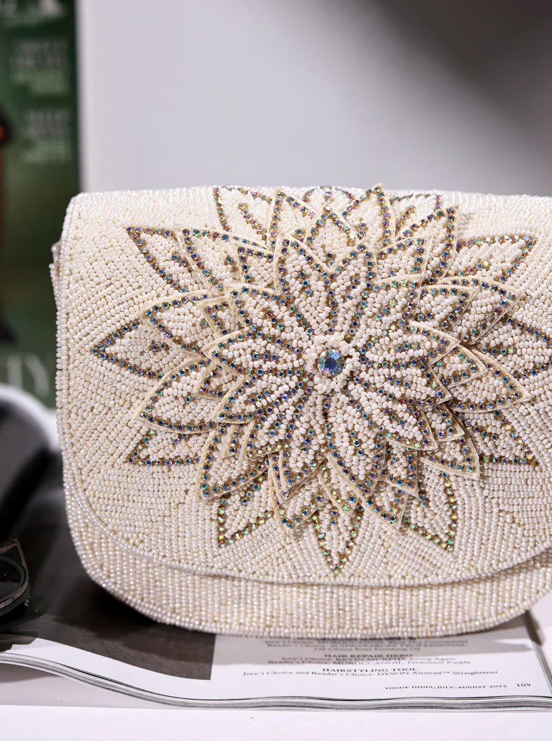 Beaded clutch with floral design on a surface