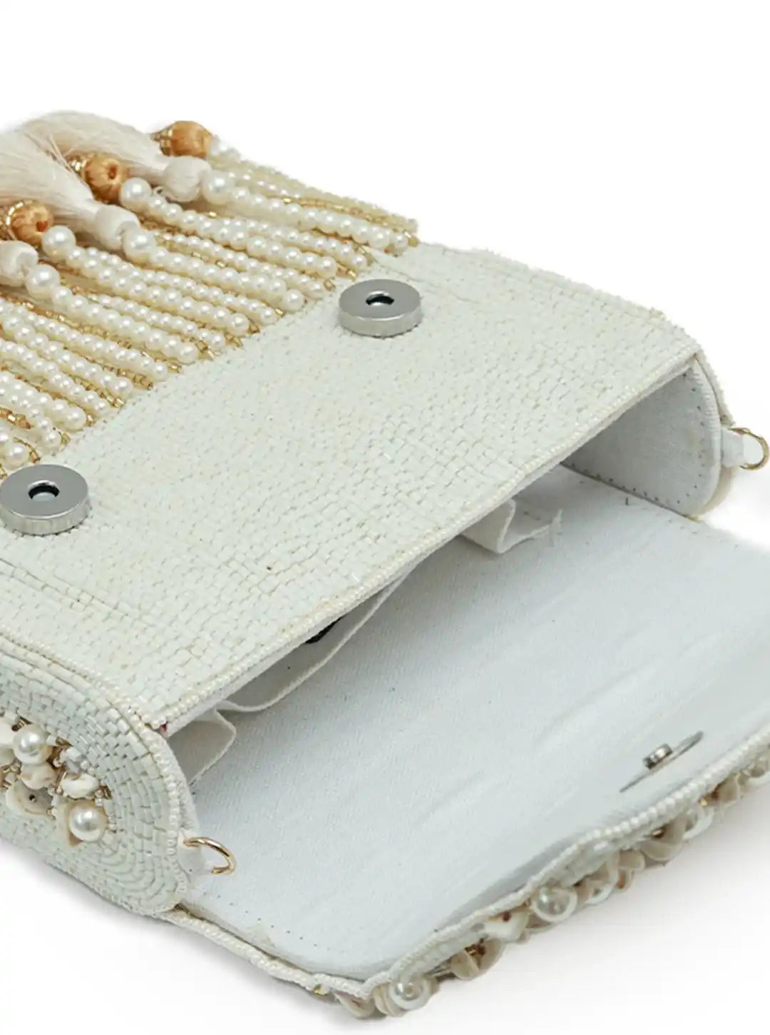 White handbag with pearl and beaded details on a white background