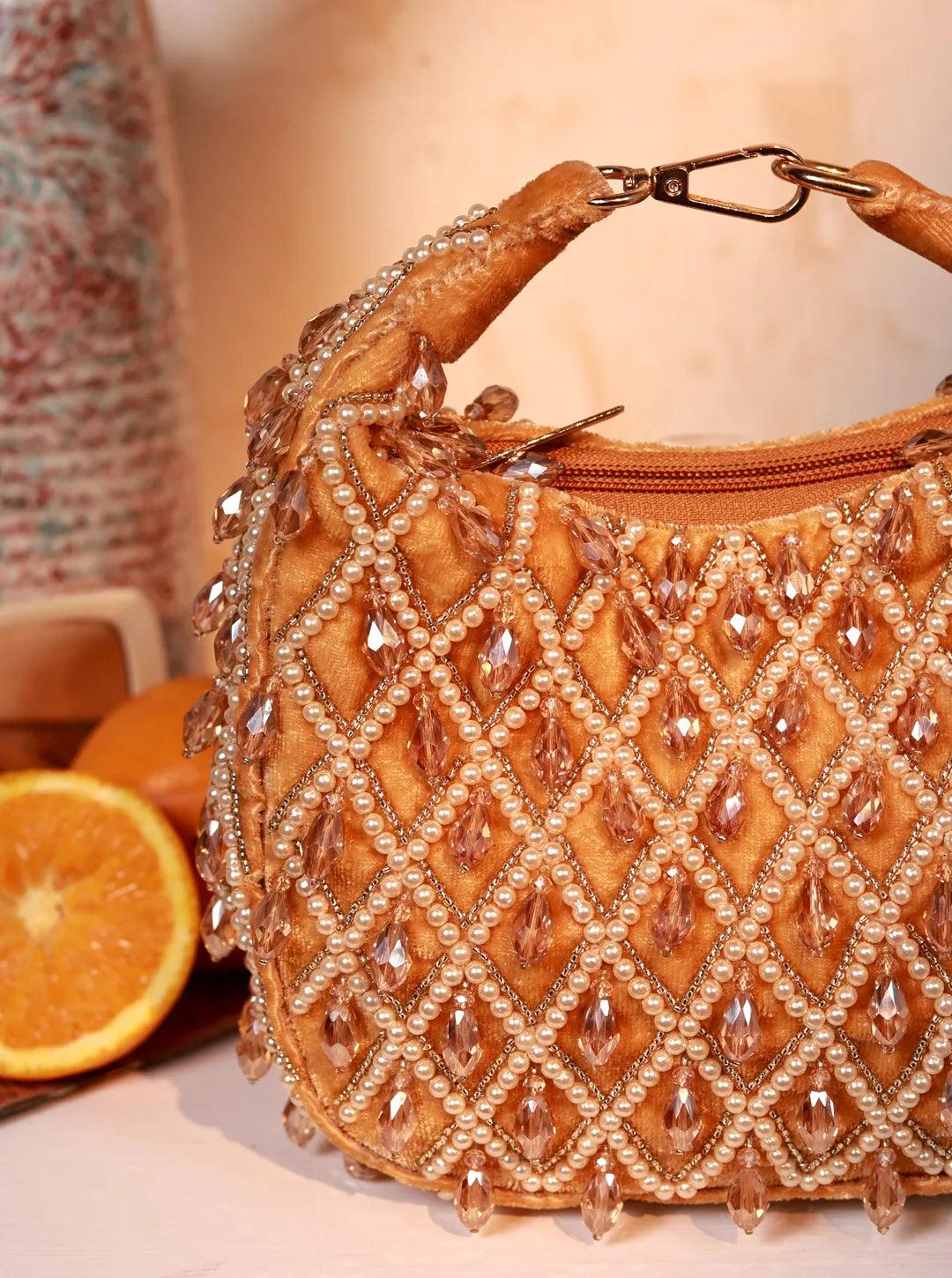 Beaded handbag with a diamond pattern on a neutral background