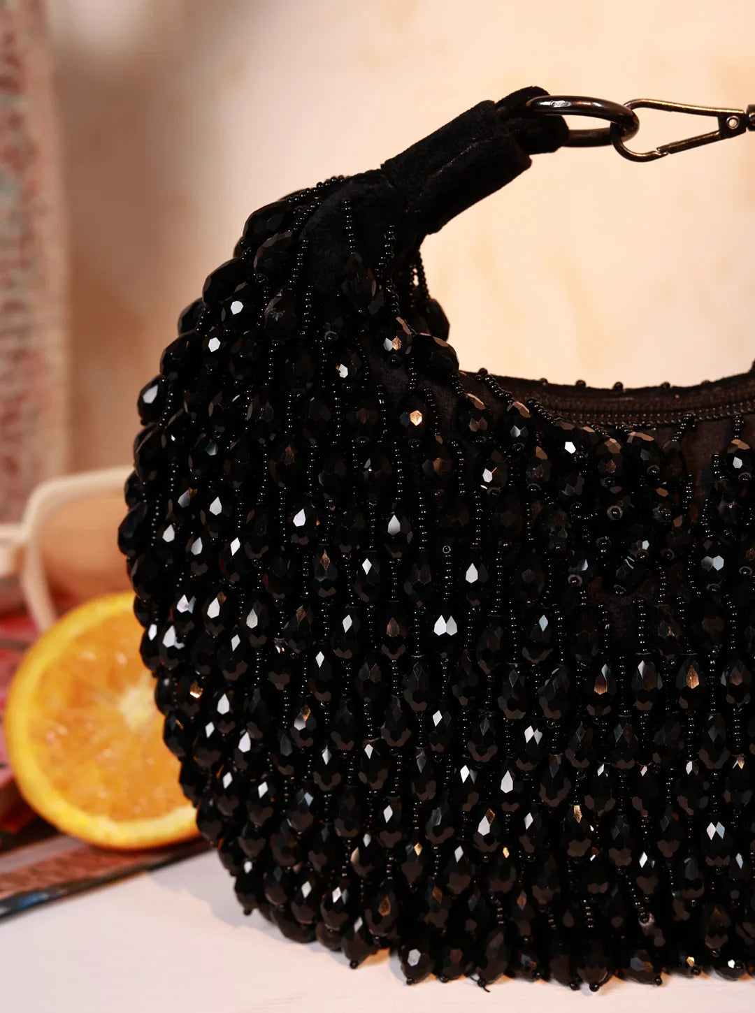 Black beaded handbag with a blurred background