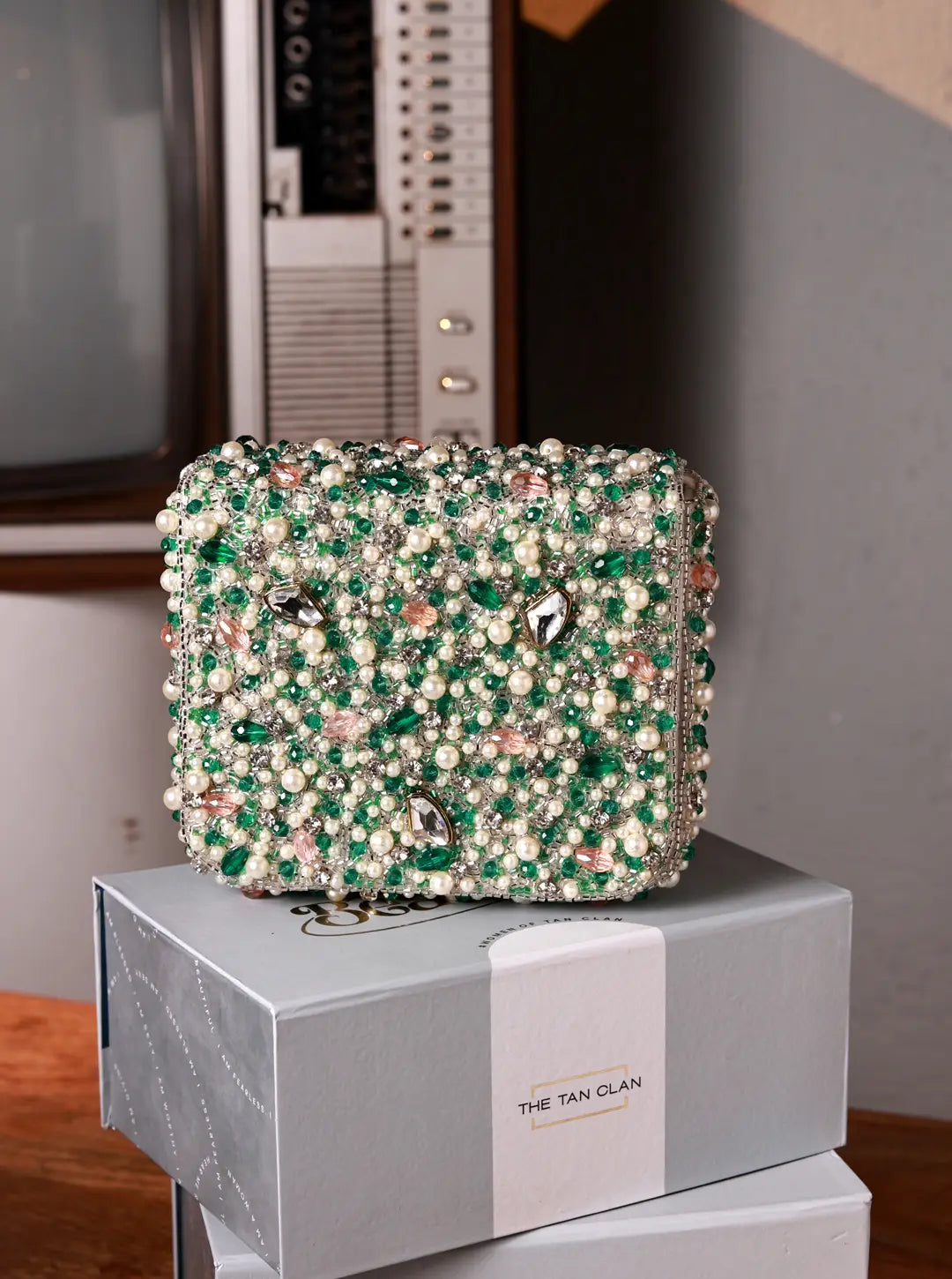Decorative box with green and white bead pattern on a gray box with 'The Tan Clan' branding.
